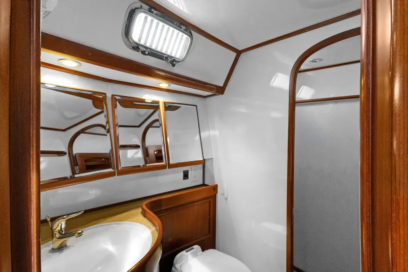 Clarity Yacht Photos Pics Luxurious bathroom interior of 2009 Hylas 54 yacht with wooden accents and modern fixtures.