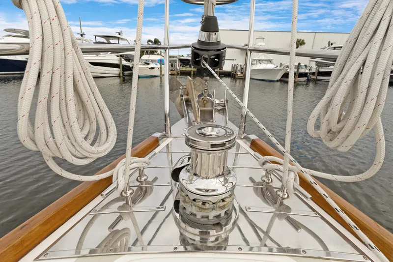 Clarity Yacht Photos Pics Bow of 2009 Hylas 54 yacht with polished winch and coiled ropes in marina.