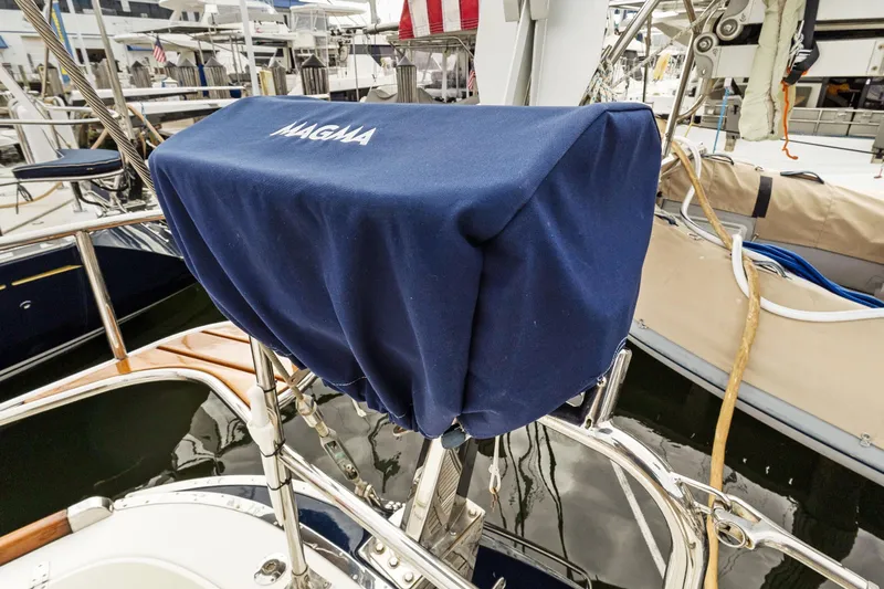 Clarity Yacht Photos Pics Covered Magma grill on 2009 Hylas 54 yacht deck, marina background.