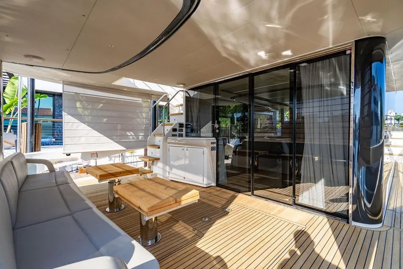 Kingship Yacht Photos Pics Luxurious 2023 Absolute 64 Navetta yacht deck with modern seating and wooden flooring.