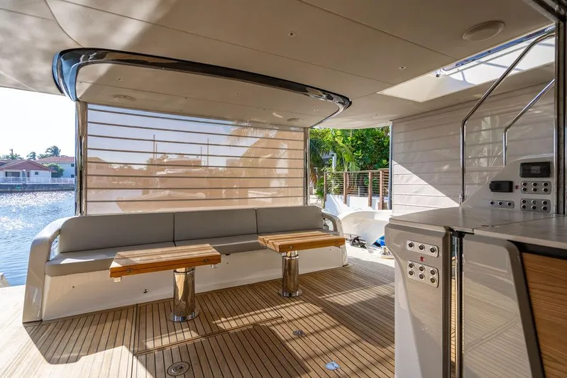 Kingship Yacht Photos Pics Luxurious 2023 Absolute 64 Navetta yacht interior with wooden deck and modern seating area.
