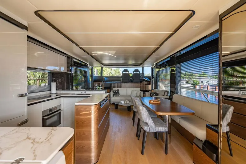 Kingship Yacht Photos Pics Luxurious interior of 2023 Absolute 64 Navetta yacht with modern kitchen and dining area.