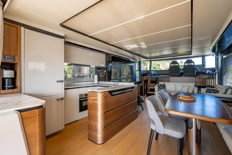 Kingship Yacht Photos Pics Luxurious interior of 2023 Absolute 64 Navetta yacht with modern kitchen and dining area.