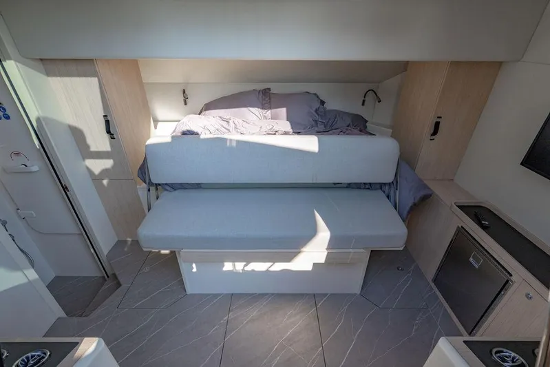 Kingship Yacht Photos Pics Interior of 2023 Absolute 64 Navetta yacht with modern seating and bed arrangement.