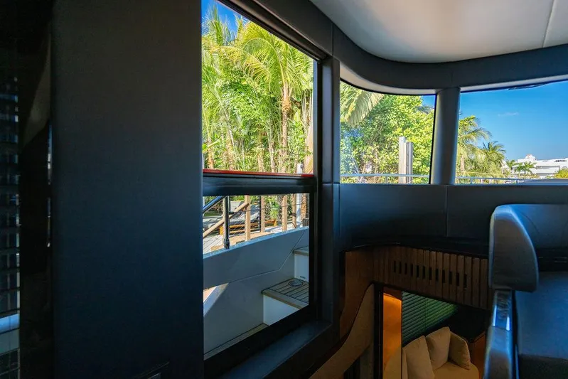 Kingship Yacht Photos Pics Interior view of 2023 Absolute 64 Navetta yacht with lush greenery outside.