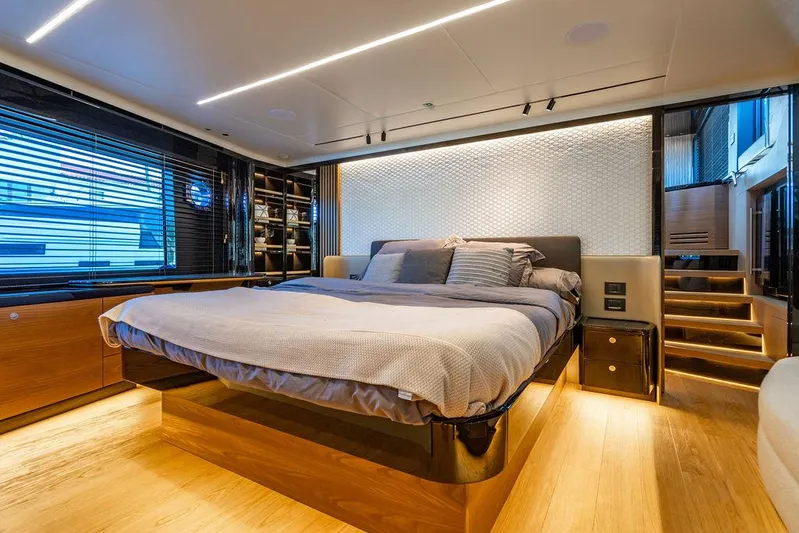 Kingship Yacht Photos Pics Luxurious bedroom interior of 2023 Absolute 64 Navetta yacht with modern design and ambient lighting.