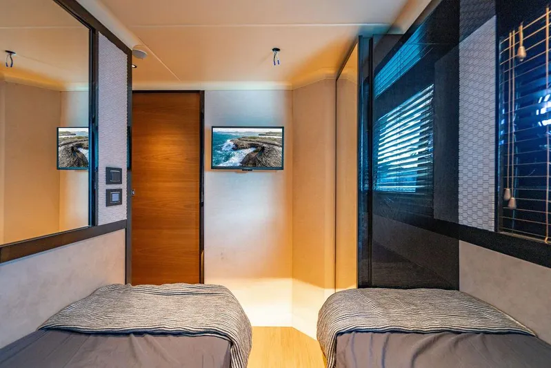 Kingship Yacht Photos Pics Luxurious twin bedroom on 2023 Absolute 64 Navetta yacht, featuring modern decor and TV.