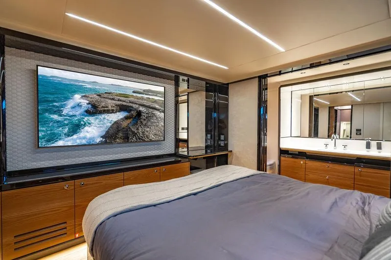 Kingship Yacht Photos Pics Luxurious bedroom interior of 2023 Absolute 64 Navetta yacht with modern decor and large TV.