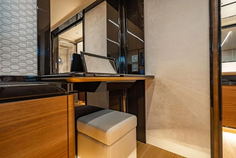 Kingship Yacht Photos Pics Luxurious interior of 2023 Absolute 64 Navetta yacht with modern desk and seating.