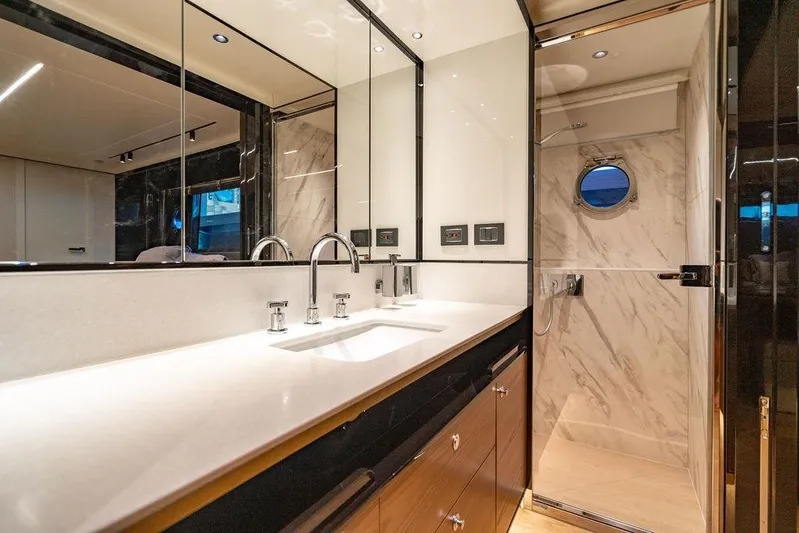 Kingship Yacht Photos Pics Luxurious bathroom in 2023 Absolute 64 Navetta yacht with modern fixtures and marble accents.