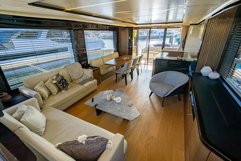 Kingship Yacht Photos Pics Luxurious interior of 2023 Absolute 64 Navetta yacht with modern furnishings and panoramic windows.