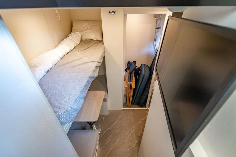 Kingship Yacht Photos Pics Cozy cabin interior of 2023 Absolute 64 Navetta yacht with bunk bed and storage.