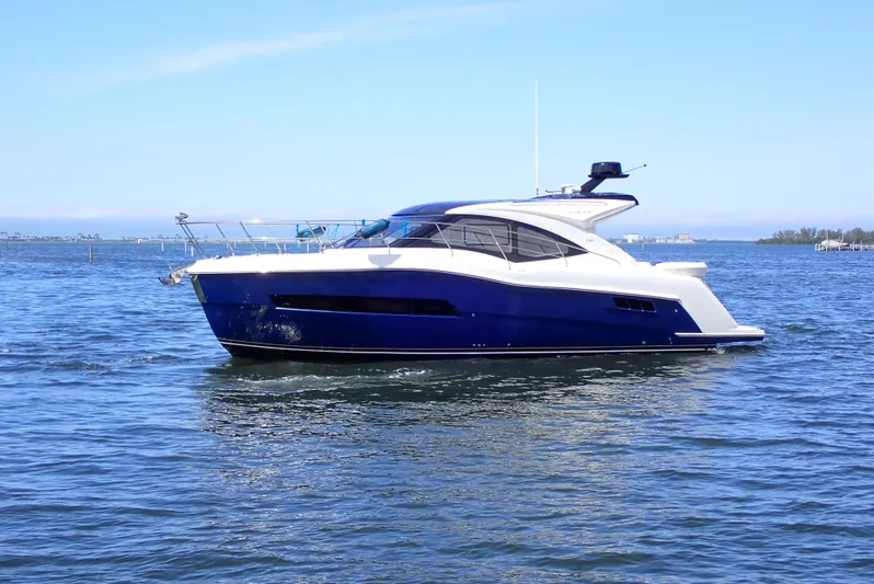  Yacht Photos Pics 2019 Carver C37 Coupe yacht cruising on open water under clear skies.