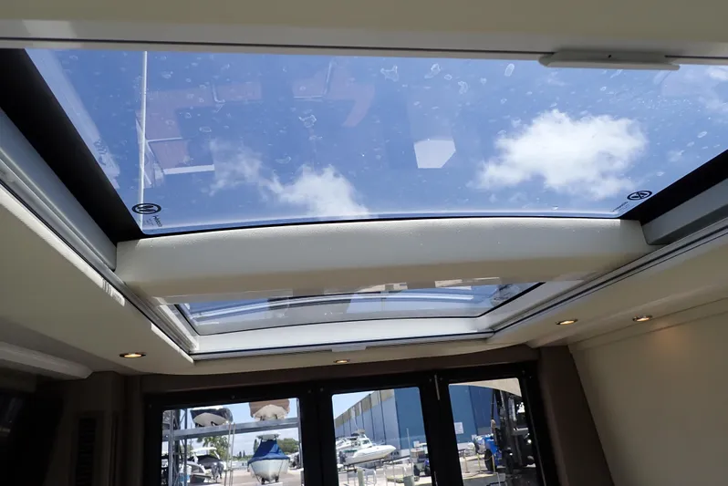 Yacht Photos Pics Sunroof view inside 2019 Carver C37 Coupe yacht, showcasing clear sky and clouds.