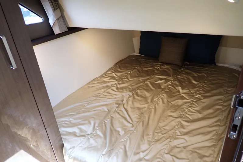  Yacht Photos Pics Cozy bedroom interior of 2019 Carver C37 Coupe yacht with plush bedding.