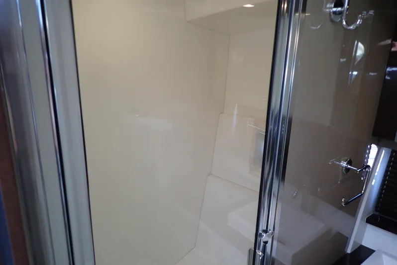  Yacht Photos Pics Shower area inside 2019 Carver C37 Coupe yacht, featuring sleek glass doors and modern fixtures.