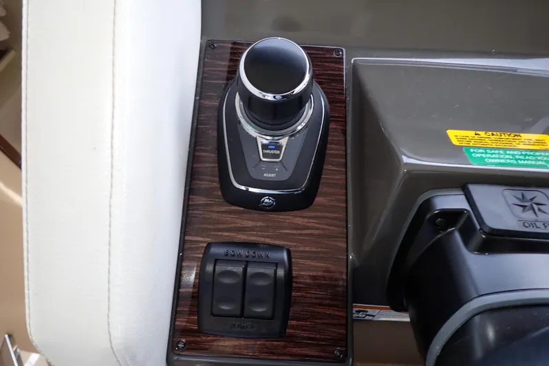  Yacht Photos Pics Control panel of 2019 Carver C37 Coupe with joystick and switches on wood finish.