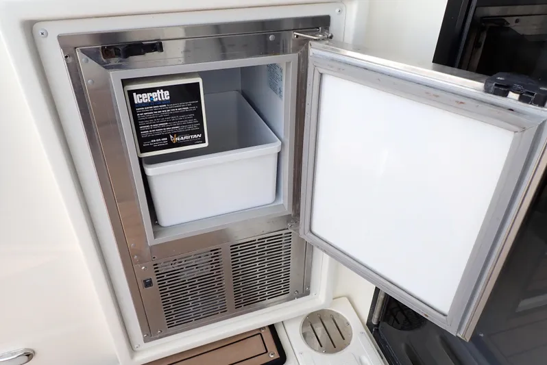  Yacht Photos Pics Open ice maker on 2019 Carver C37 Coupe yacht, showcasing interior compartment.