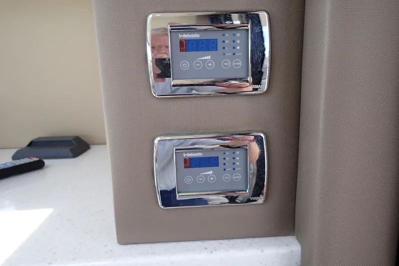  Yacht Photos Pics Control panels in a 2019 Carver C37 Coupe interior, featuring digital displays and buttons.