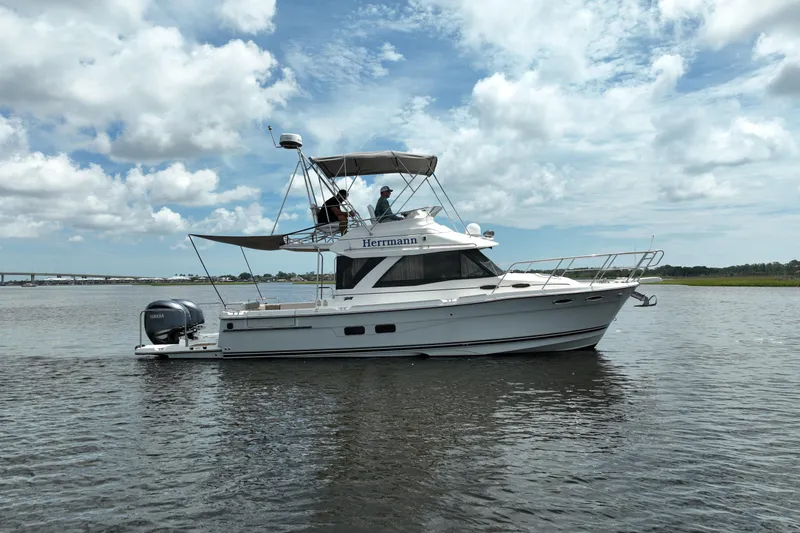 Motivated Yacht Photos Pics 2022 Cutwater C-32 CB boat cruising on calm waters under a partly cloudy sky.