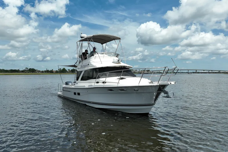 Motivated Yacht Photos Pics 2022 Cutwater C-32 CB boat on calm water under a partly cloudy sky.