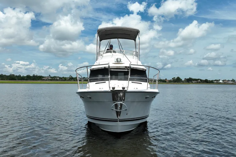 Motivated Yacht Photos Pics 2022 Cutwater C-32 CB boat on calm water under a partly cloudy sky.