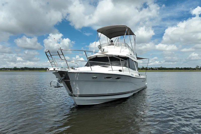 Motivated Yacht Photos Pics 2022 Cutwater C-32 CB boat on calm water under a partly cloudy sky.