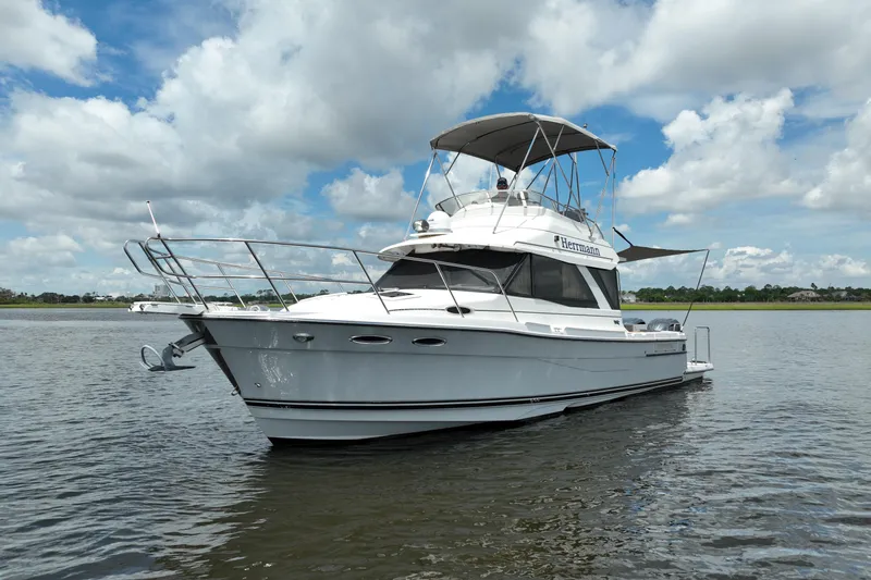 Motivated Yacht Photos Pics 2022 Cutwater C-32 CB boat on calm water under a cloudy sky.