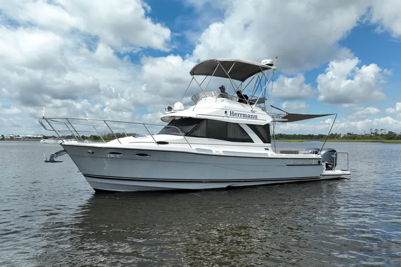 Motivated Yacht Photos Pics 2022 Cutwater C-32 CB boat on calm water under a partly cloudy sky.