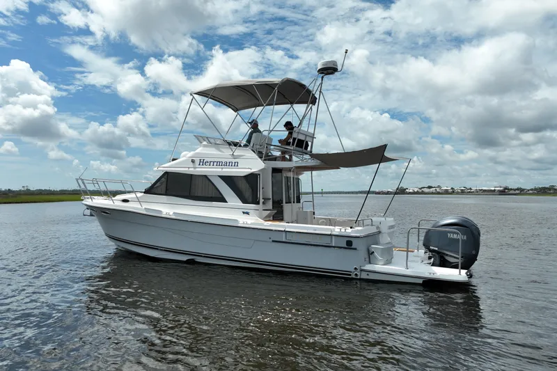 Motivated Yacht Photos Pics 2022 Cutwater C-32 CB boat on water under cloudy sky.