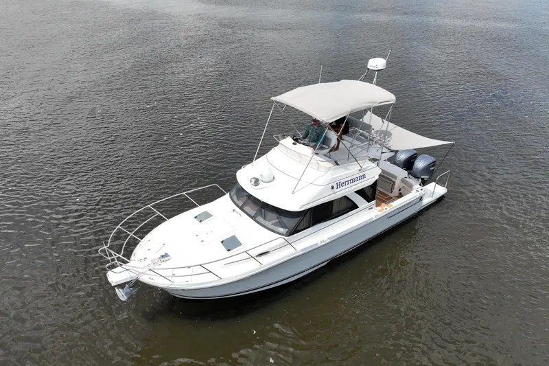 Motivated Yacht Photos Pics 2022 Cutwater C-32 CB boat on calm water, featuring a sleek design and dual engines.