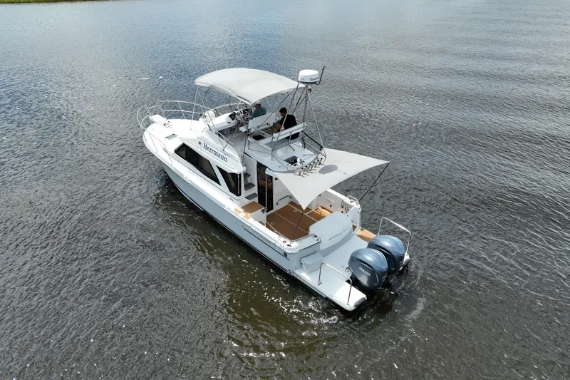 Motivated Yacht Photos Pics 2022 Cutwater C-32 CB boat cruising on calm water, featuring dual outboard engines.
