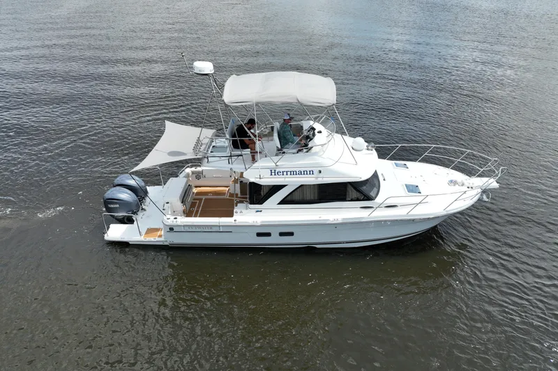 Motivated Yacht Photos Pics 2022 Cutwater C-32 CB boat cruising on calm waters, featuring dual Yamaha engines.