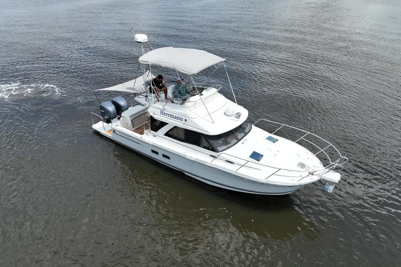 Motivated Yacht Photos Pics 2022 Cutwater C-32 CB boat cruising on calm waters, aerial view.