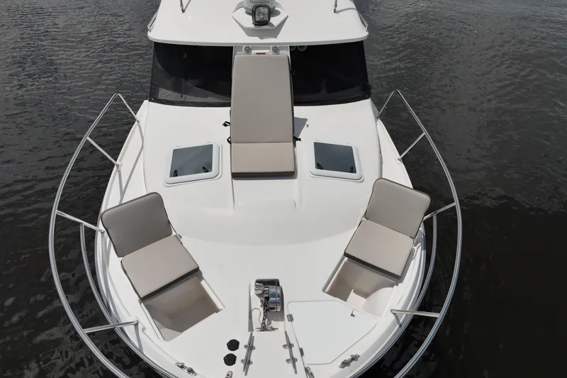 Motivated Yacht Photos Pics 2022 Cutwater C-32 CB boat deck with seating, on calm water.
