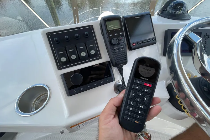 Motivated Yacht Photos Pics Control panel of 2022 Cutwater C-32 CB boat with Garmin devices and steering wheel.