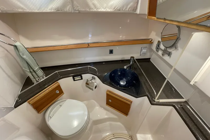 Motivated Yacht Photos Pics 2022 Cutwater C-32 CB boat bathroom with modern sink, toilet, and mirror.