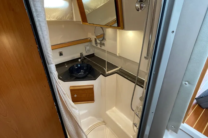 Motivated Yacht Photos Pics 2022 Cutwater C-32 CB bathroom with modern fixtures and compact design.