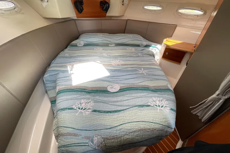 Motivated Yacht Photos Pics Cozy cabin interior of 2022 Cutwater C-32 CB with nautical-themed bedding.