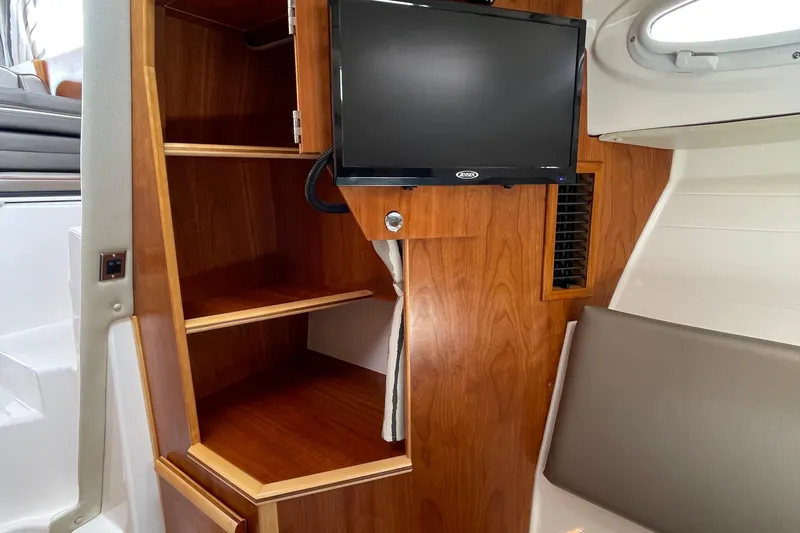 Motivated Yacht Photos Pics 2022 Cutwater C-32 CB interior with wooden shelves and mounted TV.