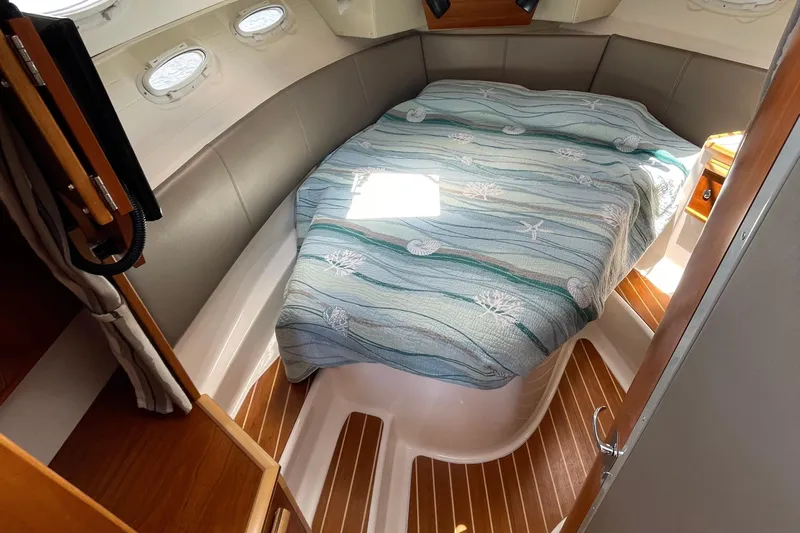 Motivated Yacht Photos Pics Cozy cabin interior of 2022 Cutwater C-32 CB with nautical-themed bedding.