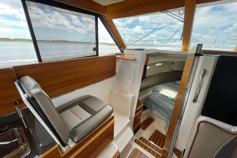 Motivated Yacht Photos Pics 2022 Cutwater C-32 CB interior with seating, cabin, and scenic water view.
