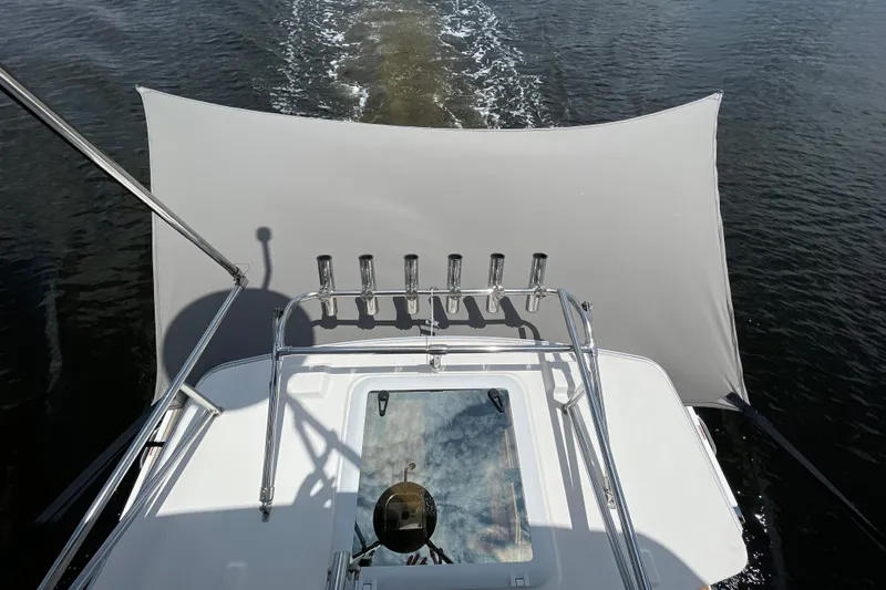 Motivated Yacht Photos Pics 2022 Cutwater C-32 CB boat with canopy, cruising on water.