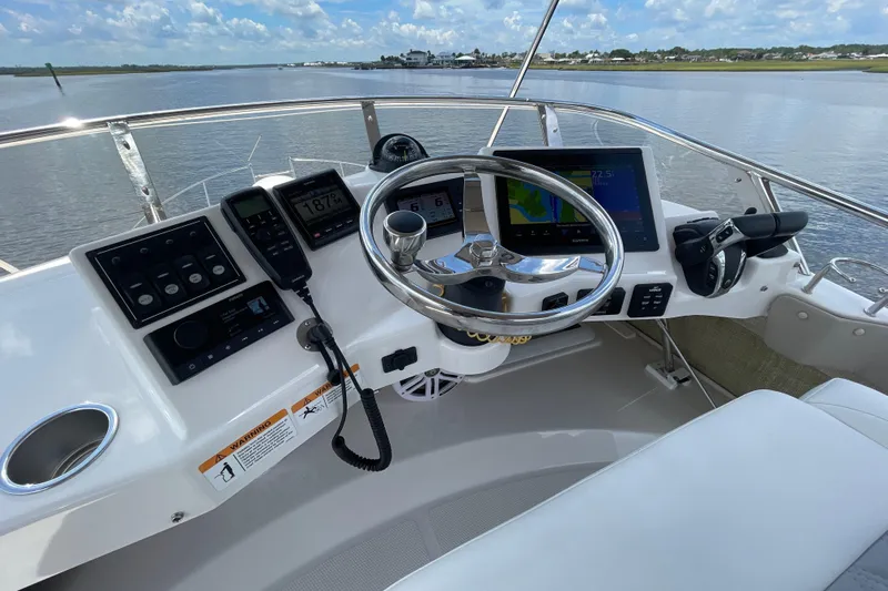 Motivated Yacht Photos Pics Helm of 2022 Cutwater C-32 CB boat with modern navigation equipment and scenic water view.