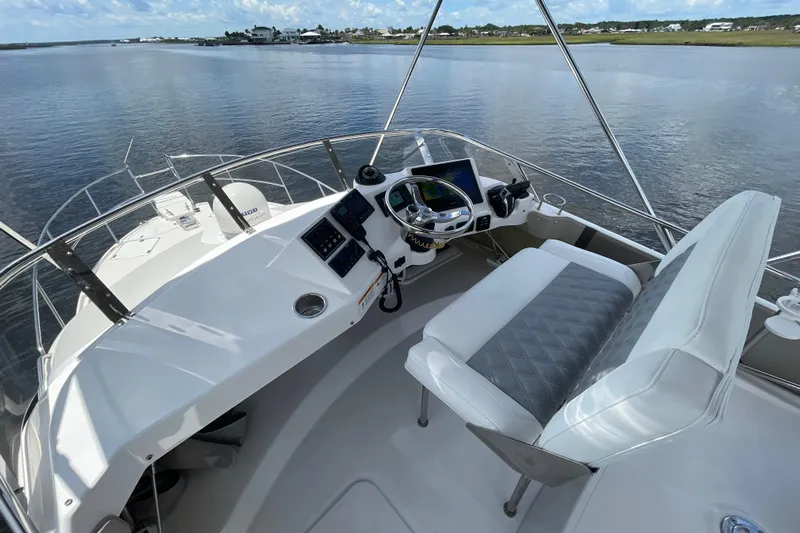 Motivated Yacht Photos Pics 2022 Cutwater C-32 CB boat helm with modern controls and panoramic water view.