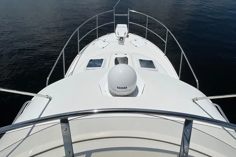 Motivated Yacht Photos Pics 2022 Cutwater C-32 CB boat deck with railing, navigating calm waters.