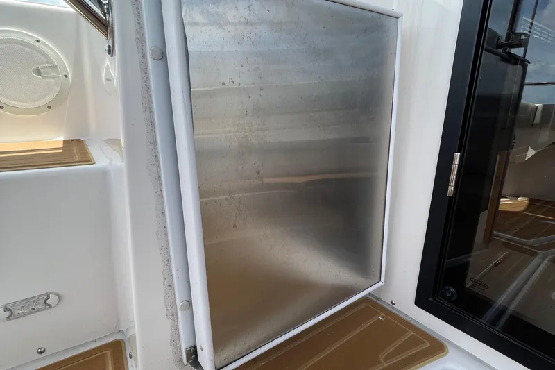 Motivated Yacht Photos Pics 2022 Cutwater C-32 CB boat interior with stainless steel panel and speaker.