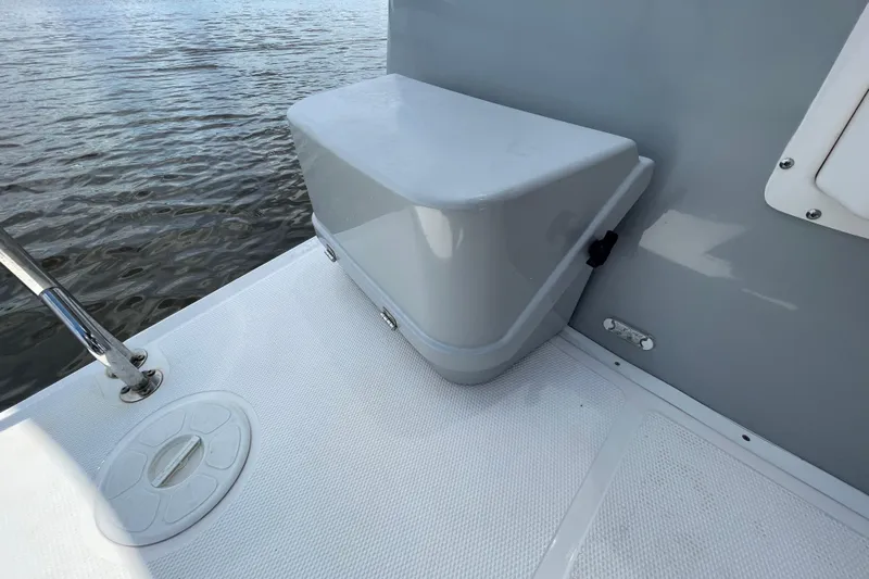Motivated Yacht Photos Pics 2022 Cutwater C-32 CB boat deck with storage compartment by the water.