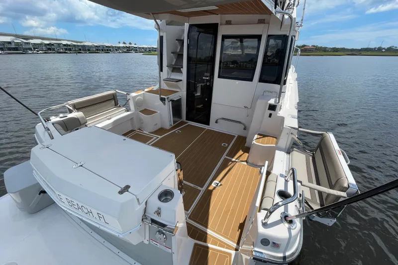 Motivated Yacht Photos Pics 2022 Cutwater C-32 CB boat with spacious deck and seating, docked by the water.