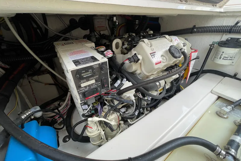 Motivated Yacht Photos Pics Engine compartment of 2022 Cutwater C-32 CB boat, showcasing mechanical components and wiring.